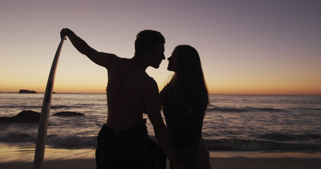 Romantic Couple Silhouette on Beach During Sunset with Surfboard - Free Images, Stock Photos and Pictures on Pikwizard.com