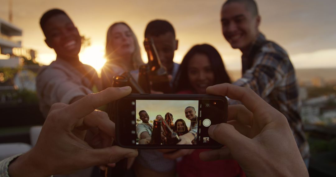 Friends Celebrating at Sunset Taking Group Selfie on Rooftop - Free Images, Stock Photos and Pictures on Pikwizard.com