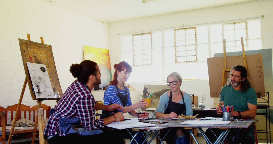 Aspiring Artists Sharing Ideas in Vibrant Studio Setting