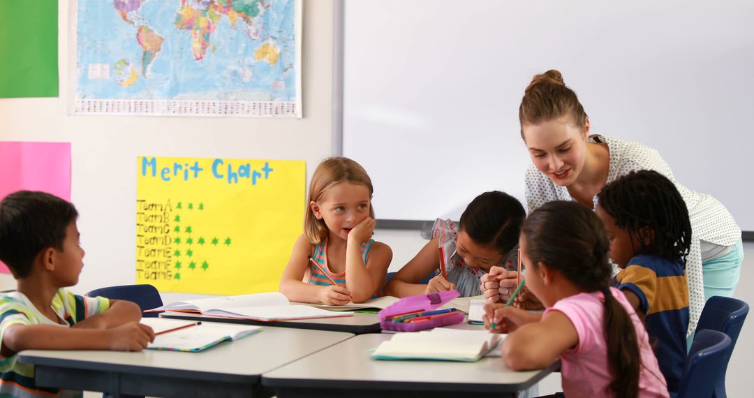 Female teacher interacting with diverse students in classroom - Free Images, Stock Photos and Pictures on Pikwizard.com