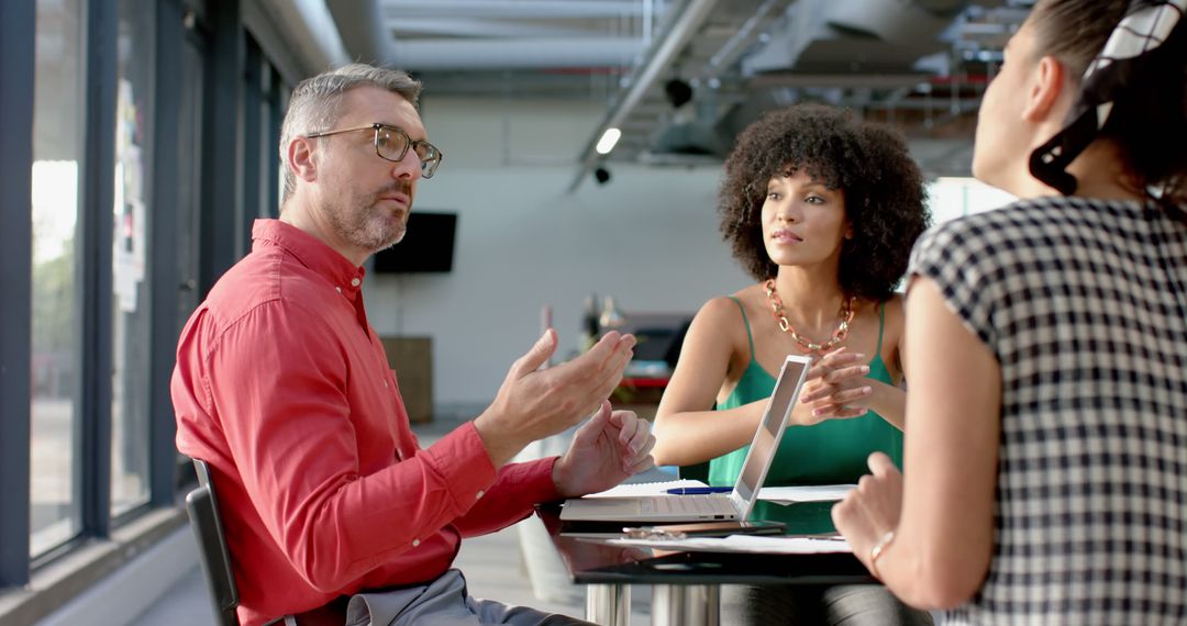 Diverse Team Engaged in Dynamic Office Discussion