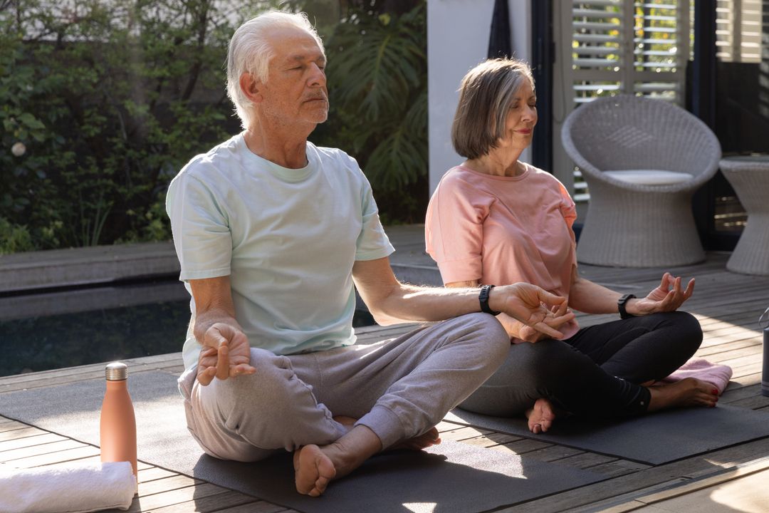 Senior Couple Meditating by Pool in Serene Backyard