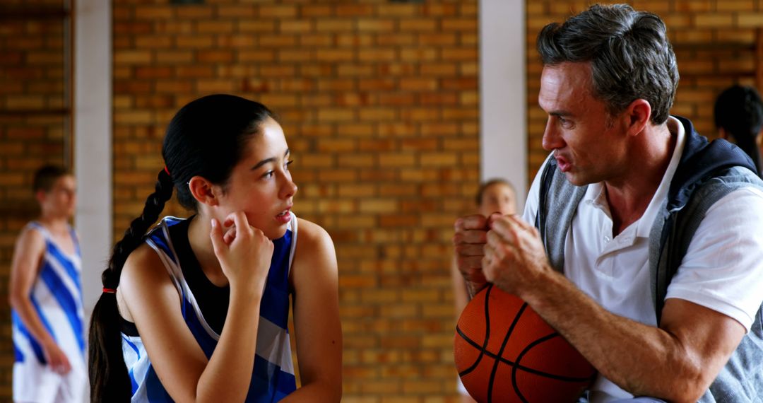 Youth Basketball Player Listening to Coach's Instructions During Practice - Free Images, Stock Photos and Pictures on Pikwizard.com