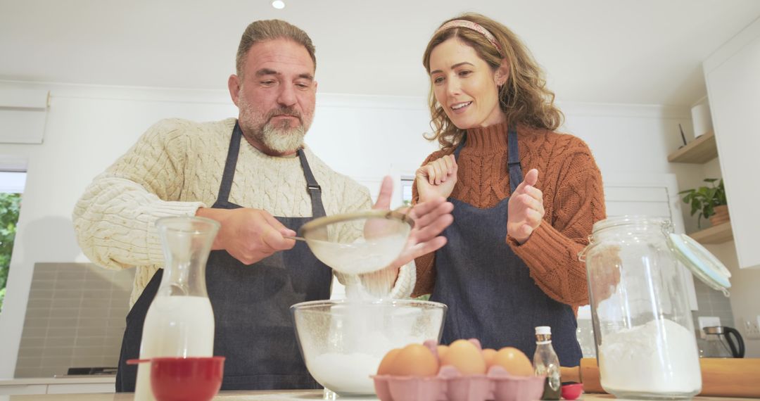 Joyful Couple Baking Together in Kitchen Embracing Culinary Art
