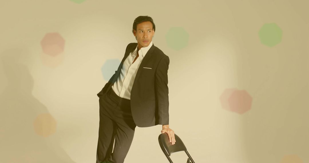 Stylish Man in Black Suit with Folding Chair, Studio Concept
