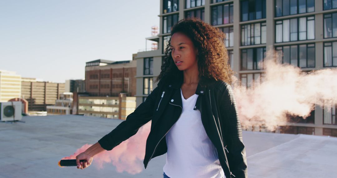 Young Woman Holding Smoke Bomb on Rooftop - Free Images, Stock Photos and Pictures on Pikwizard.com