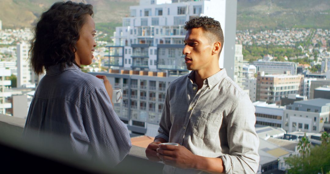 Diverse Colleagues Conversing on Urban Balcony
