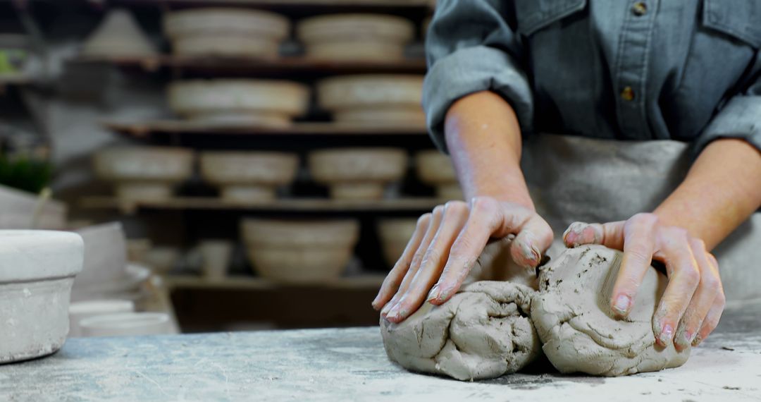 Hands Shaping Clay in Pottery Workshop Showcasing Craftsmanship