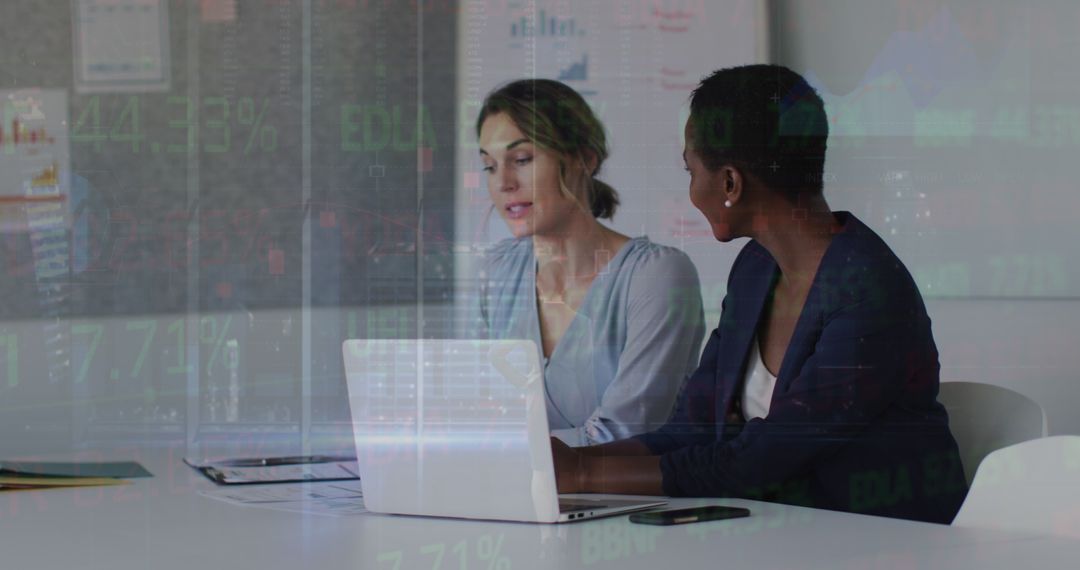 Two Businesswomen Analyzing Financial Data on Laptop - Free Images, Stock Photos and Pictures on Pikwizard.com