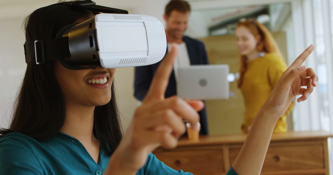 Smiling Woman Using Virtual Reality Headset in Modern Office - Free Images, Stock Photos and Pictures on Pikwizard.com