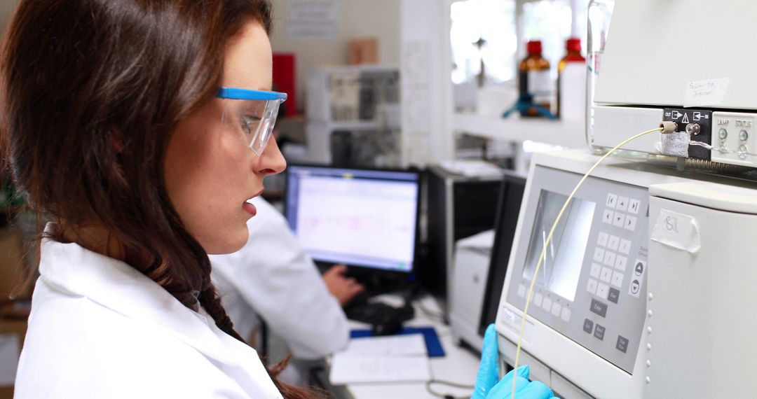 Female Scientist Operates Lab Equipment in Modern Laboratory - Free Images, Stock Photos and Pictures on Pikwizard.com