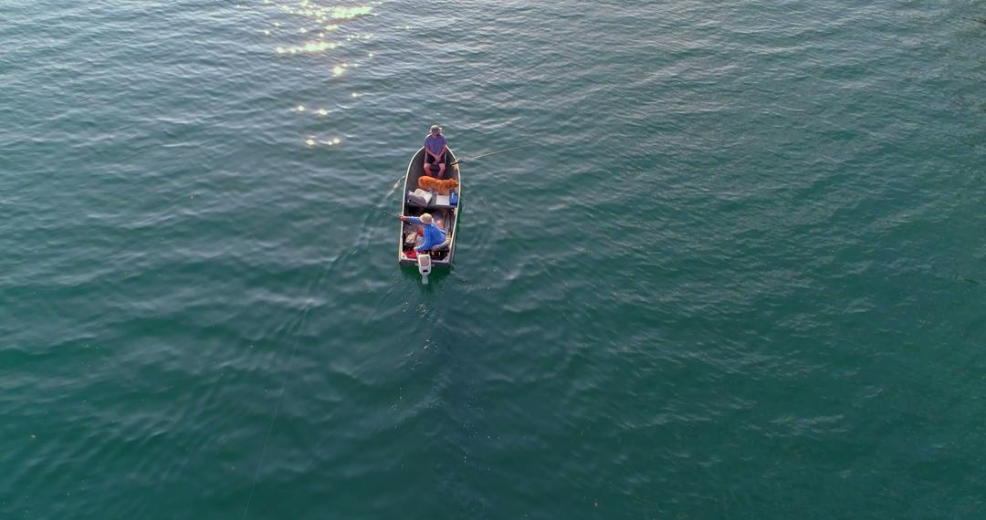 Aerial View of Man in Small Boat on Tranquil Water - Free Images, Stock Photos and Pictures on Pikwizard.com