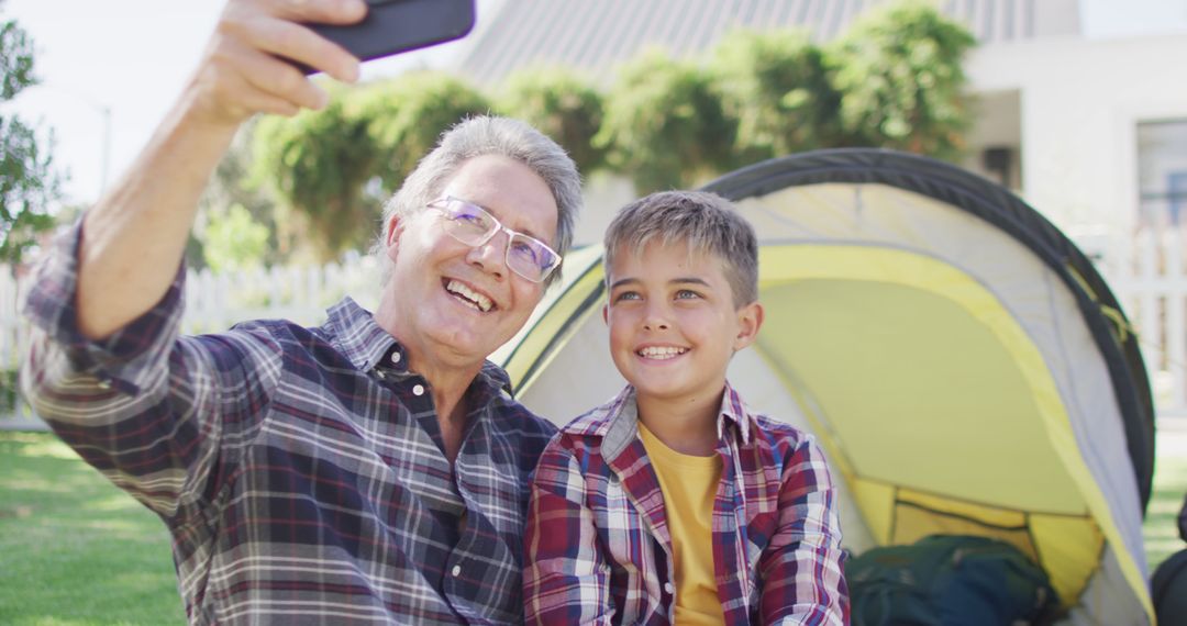 Father and Son Taking Selfies by Tent in Garden - Free Images, Stock Photos and Pictures on Pikwizard.com