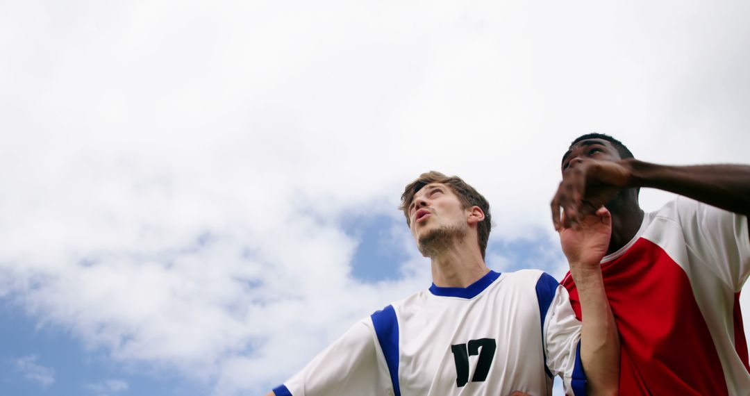 Soccer Players in Action Against Blue Sky - Free Images, Stock Photos and Pictures on Pikwizard.com