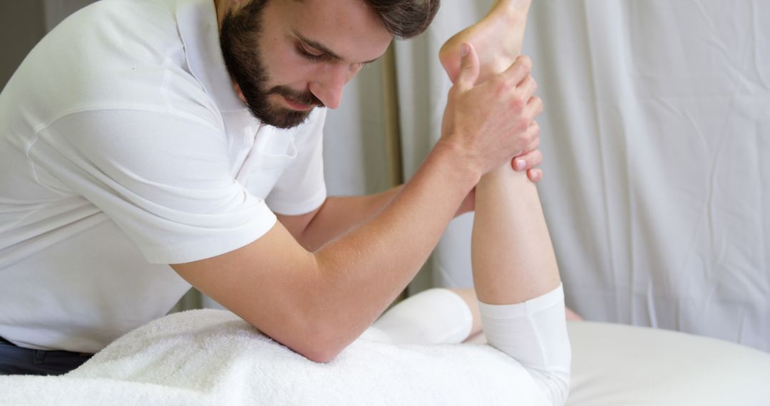 Physiotherapist Treating a Patient's Leg Injury - Free Images, Stock Photos and Pictures on Pikwizard.com