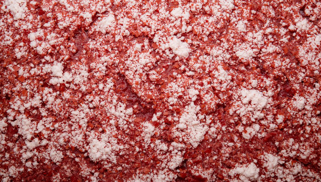 Macro red crystalline spice texture with white salt crystals filling frame