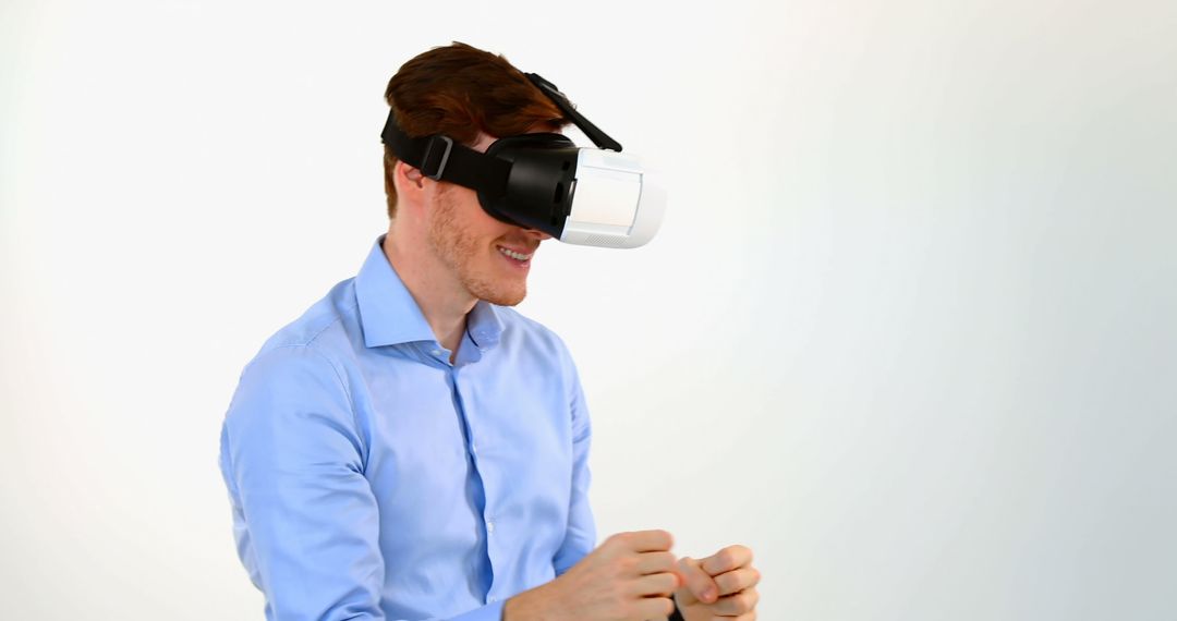 Young Man Experiencing Virtual Reality with Headset in White Background - Free Images, Stock Photos and Pictures on Pikwizard.com
