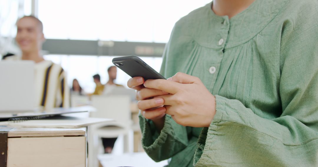Young Adult Engaging with Smartphone in Classroom Environment
