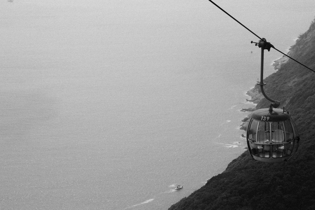 Cable Car over Mountain Cliff and Ocean - Free Images, Stock Photos and Pictures on Pikwizard.com