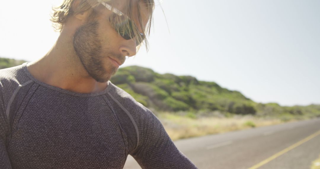 Athletic Man Resting on Rural Road During Sunny Day - Free Images, Stock Photos and Pictures on Pikwizard.com