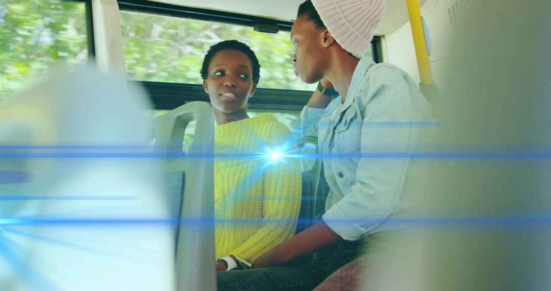 Two Women Engaged in Conversation on Public Bus