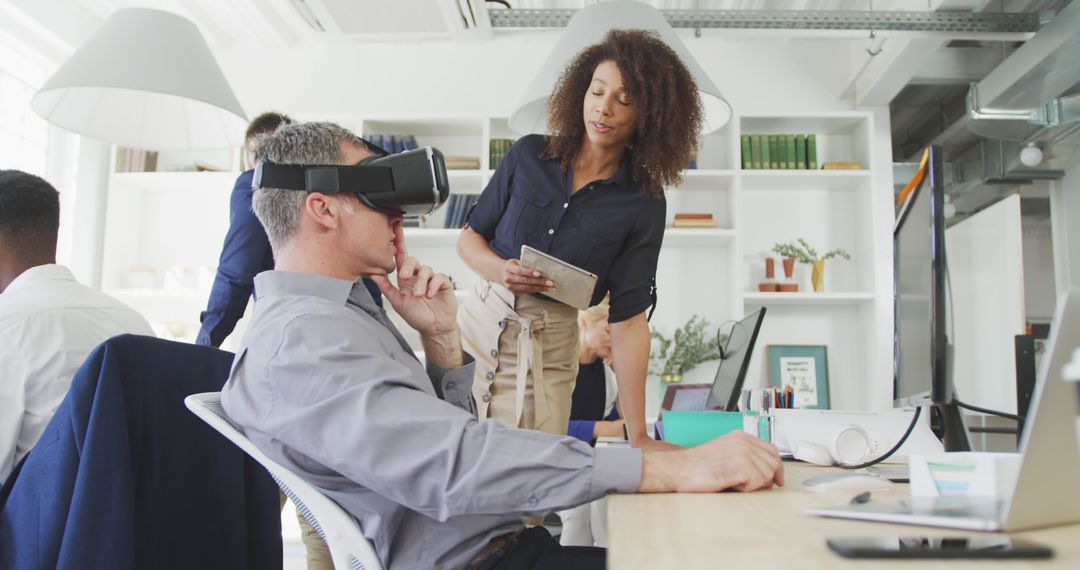 Colleagues experimenting with virtual reality in modern office - Free Images, Stock Photos and Pictures on Pikwizard.com