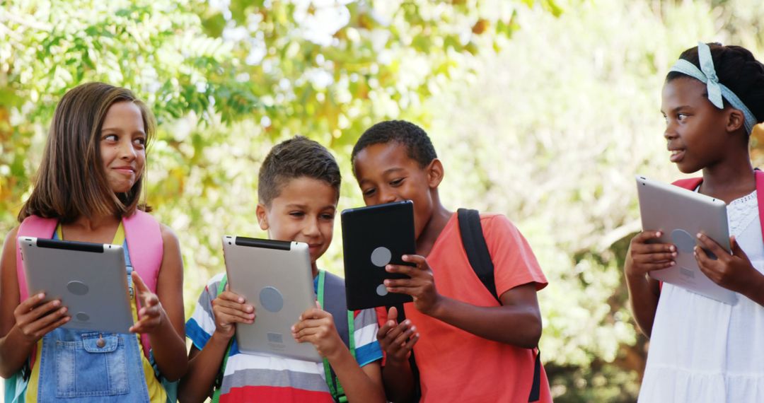 Group of Diverse Children Using Tablets Outdoors - Free Images, Stock Photos and Pictures on Pikwizard.com