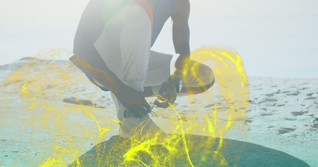 Fit Man Tying Shoelaces with Digital Effects at Beach