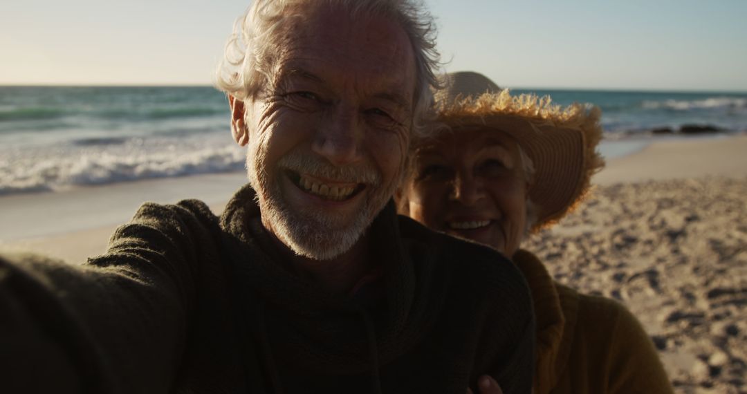 Happy senior couple taking selfie at the beach during sunset - Free Images, Stock Photos and Pictures on Pikwizard.com