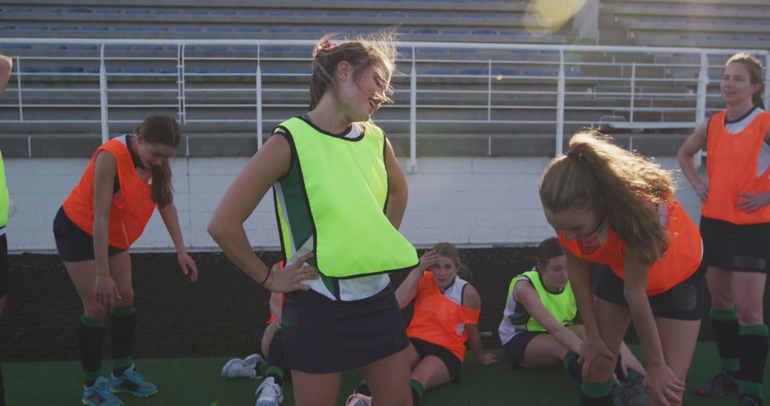 Exhausted Female Hockey Team Taking Rest Under Sunlight