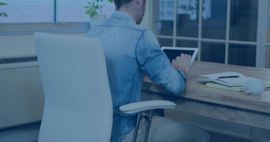 Casual Professional Using Tablet in Modern Office Setting