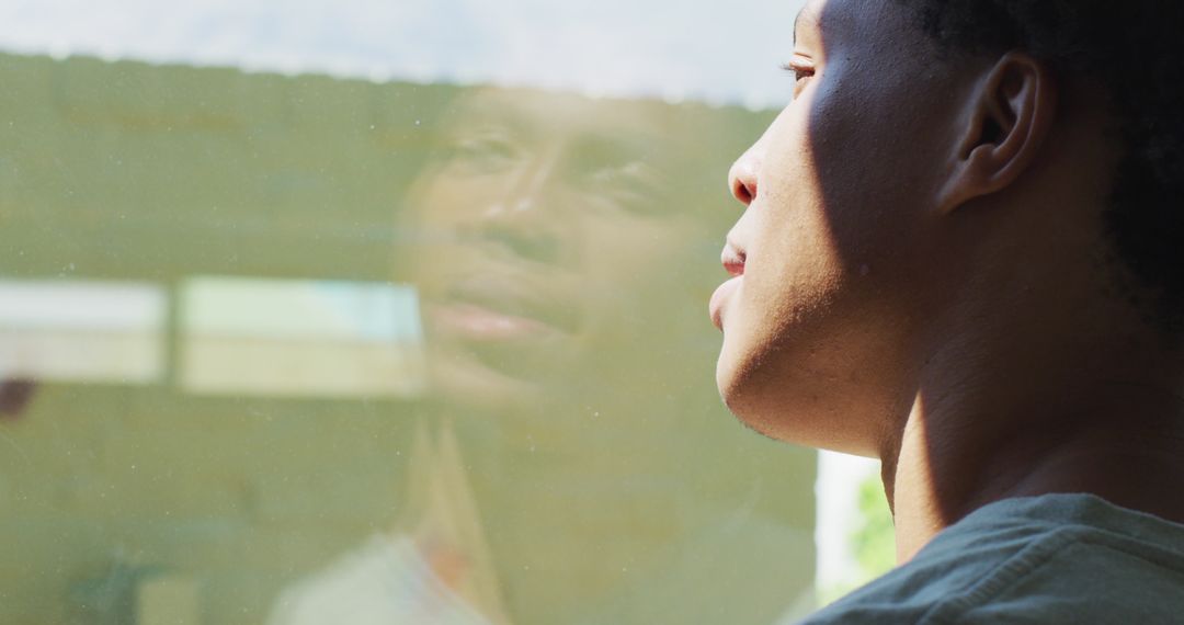 Reflective Moment of Man Looking Through Window with Coffee