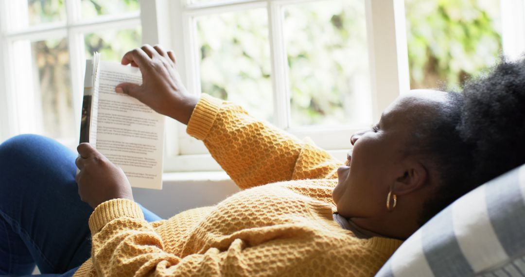 African American Woman Relaxing and Reading Book at Home - Free Images, Stock Photos and Pictures on Pikwizard.com