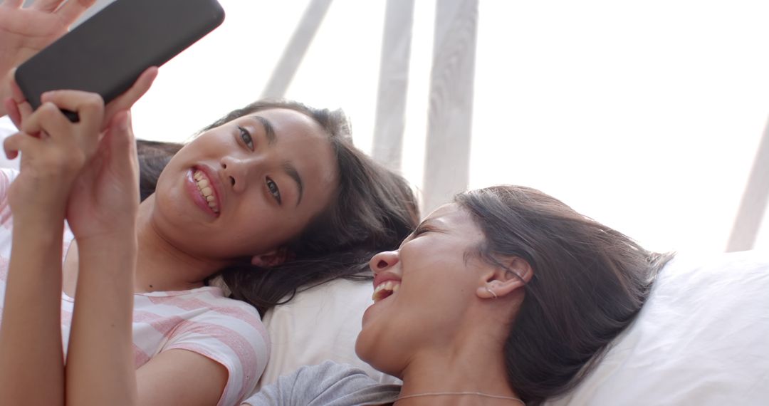 Teen Girls Relaxing with Tablet at Home