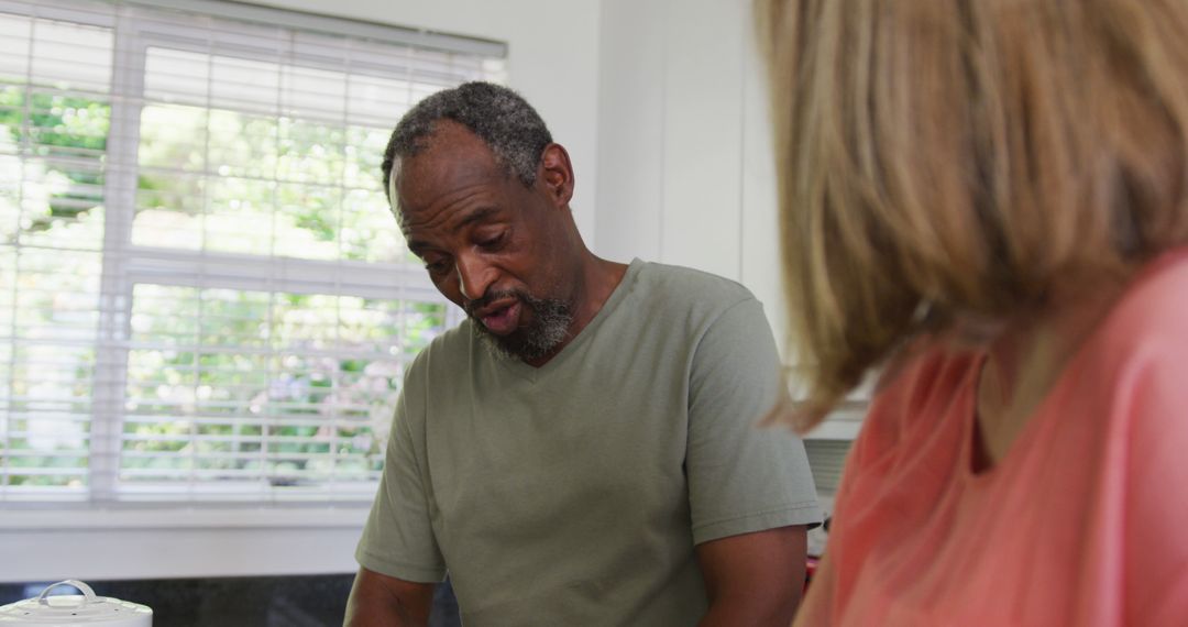 Senior Couple Cooking Together at Home and Conversing