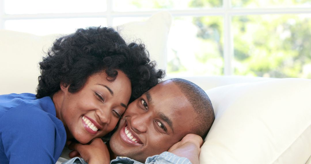 Happy Couple Relaxing on Couch Enjoying Quality Time Together