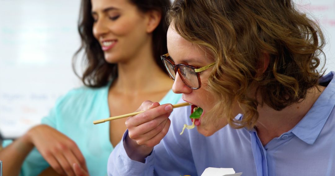 Professional Women Enjoying Healthy Takeout Lunch in Office - Free Images, Stock Photos and Pictures on Pikwizard.com