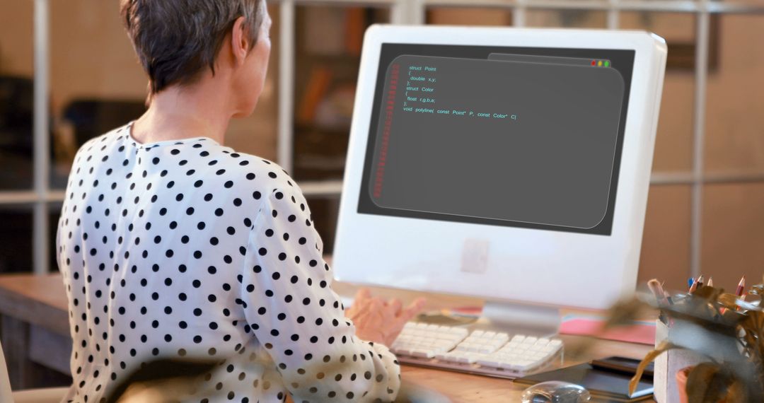 Woman Coding on Computer in Office, Back View, Polka Dot Shirt - Free Images, Stock Photos and Pictures on Pikwizard.com