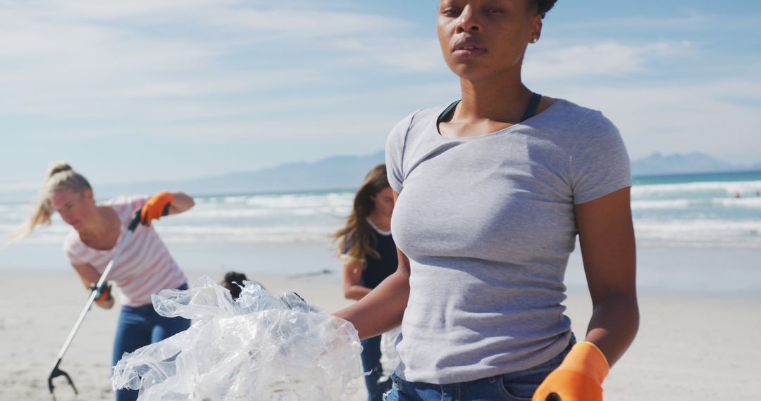 Group of Volunteers Cleaning Beach Collecting Plastic Waste - Free Images, Stock Photos and Pictures on Pikwizard.com