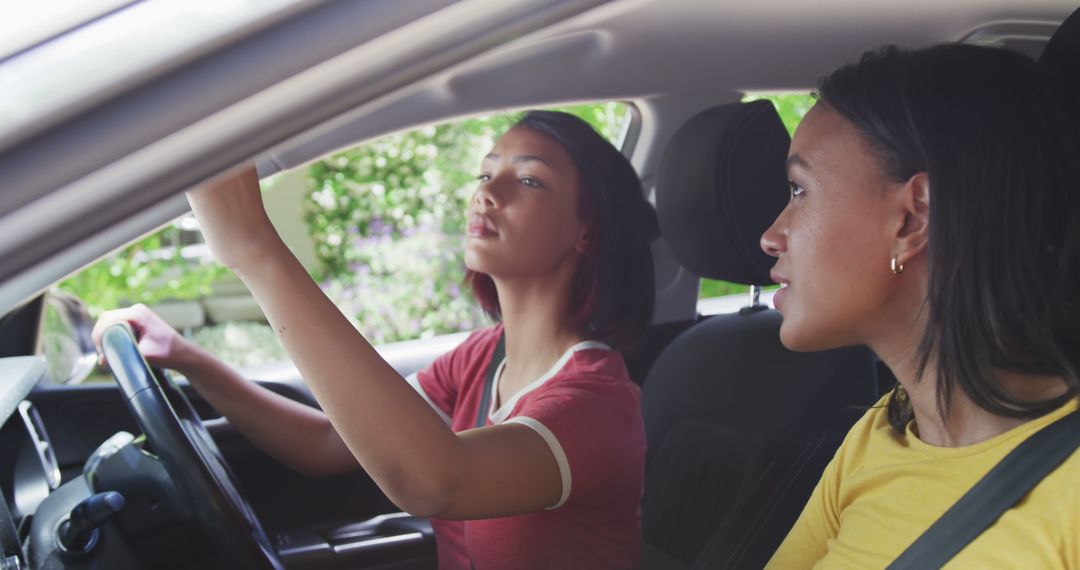 Young Women Adjusting Rearview Mirror in Car - Free Images, Stock Photos and Pictures on Pikwizard.com