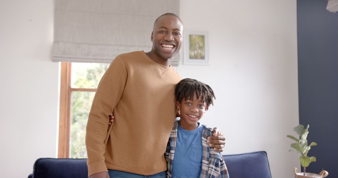 Father and Son Smiling at Home Together - Free Images, Stock Photos and Pictures on Pikwizard.com