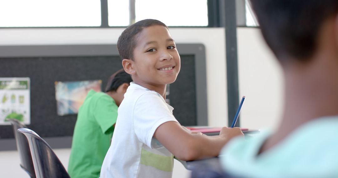 Boy Joyfully Engaged in Classroom Learning Environment Smiles