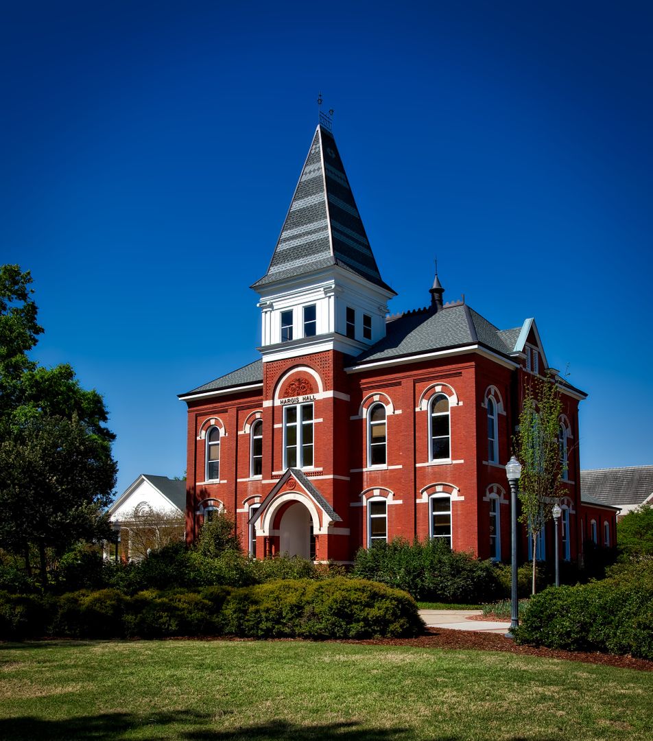 Historic Red Brick Building with Steeple against Clear Blue Sky - Free Images, Stock Photos and Pictures on Pikwizard.com