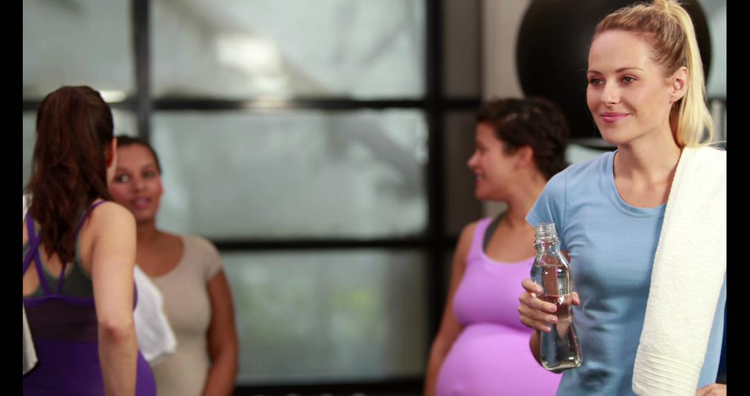 Pregnant Women Relaxing and Hydrating During Fitness Class - Free Images, Stock Photos and Pictures on Pikwizard.com