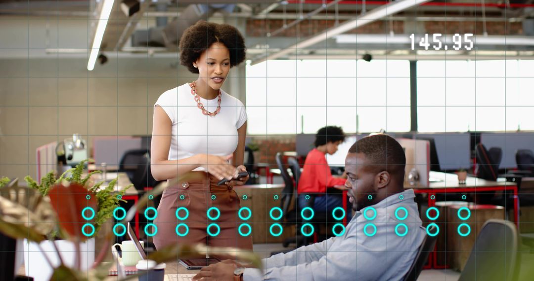 Young professionals collaborating in open office with digital analytics overlay