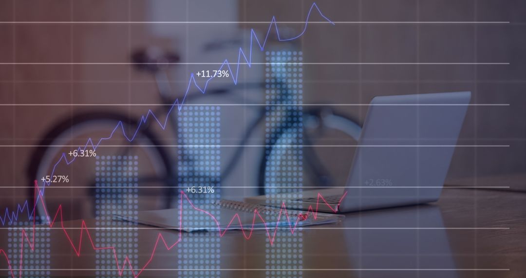 Office Desk with Laptop Overlayed with Statistical Graphs