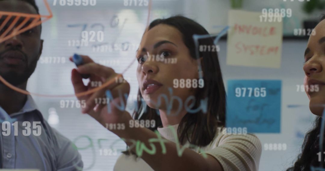 Diverse Business Team Analyzing Data with Digital Visuals