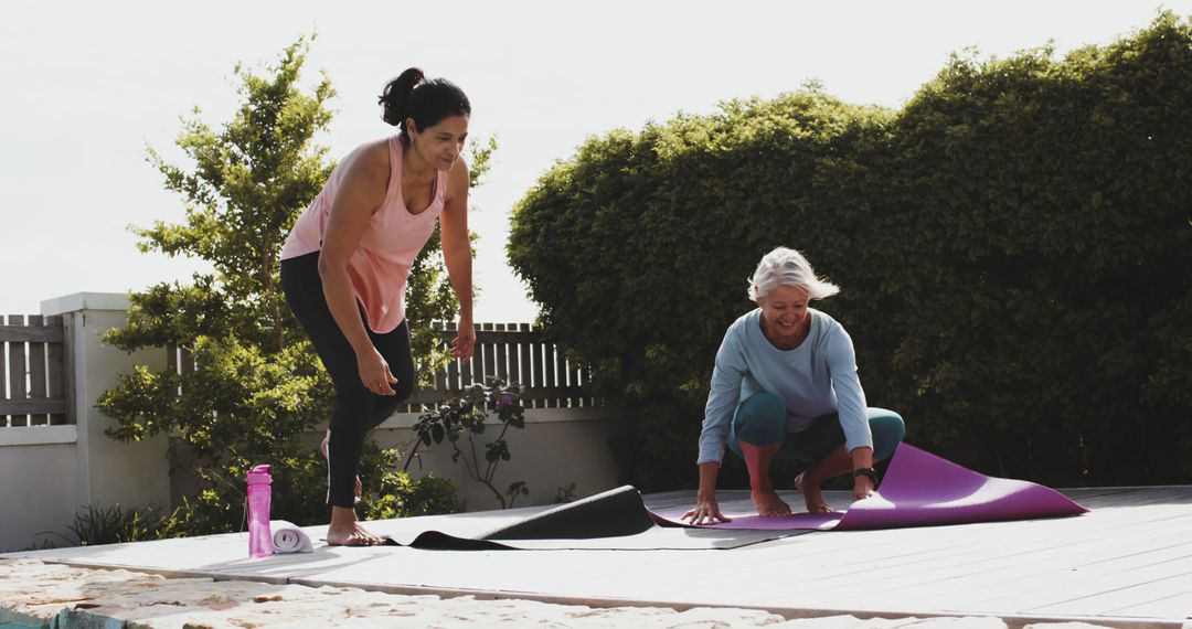 Senior Women Unrolling Yoga Mats Outdoors for Exercise - Free Images, Stock Photos and Pictures on Pikwizard.com