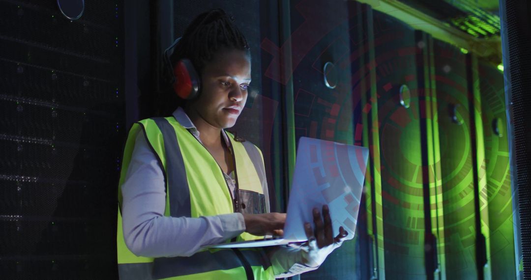 African American Female Engineer Analyzing Data in Server Room