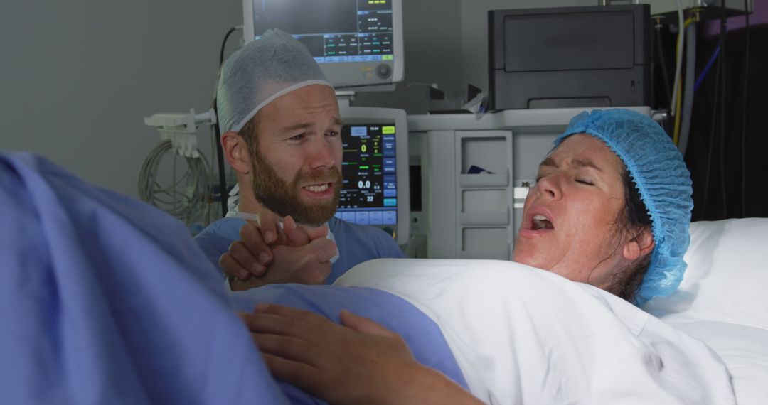 Front view of Caucasian man comforting pregnant woman during labor in operation theater at hospital - Free Images, Stock Photos and Pictures on Pikwizard.com